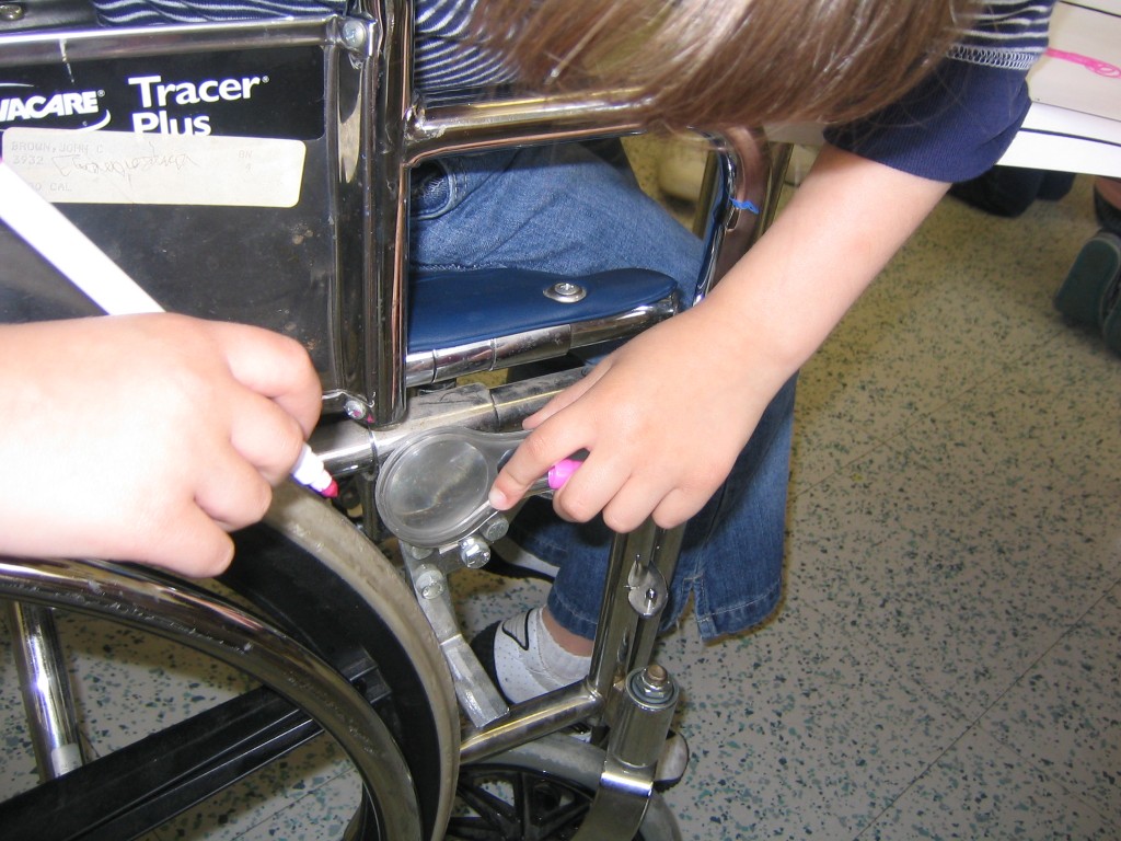 looking closely at the wheelchair
